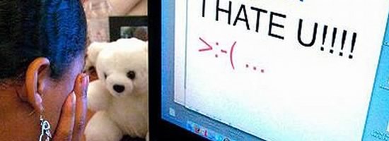 A computer with the message "I hate you" on the screen