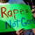 Someone holding up a sign saying 'Rape = not good