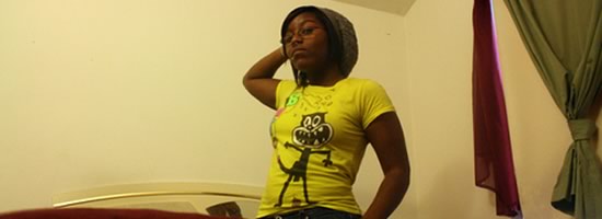 A young woman looking into the camera, posing strongly